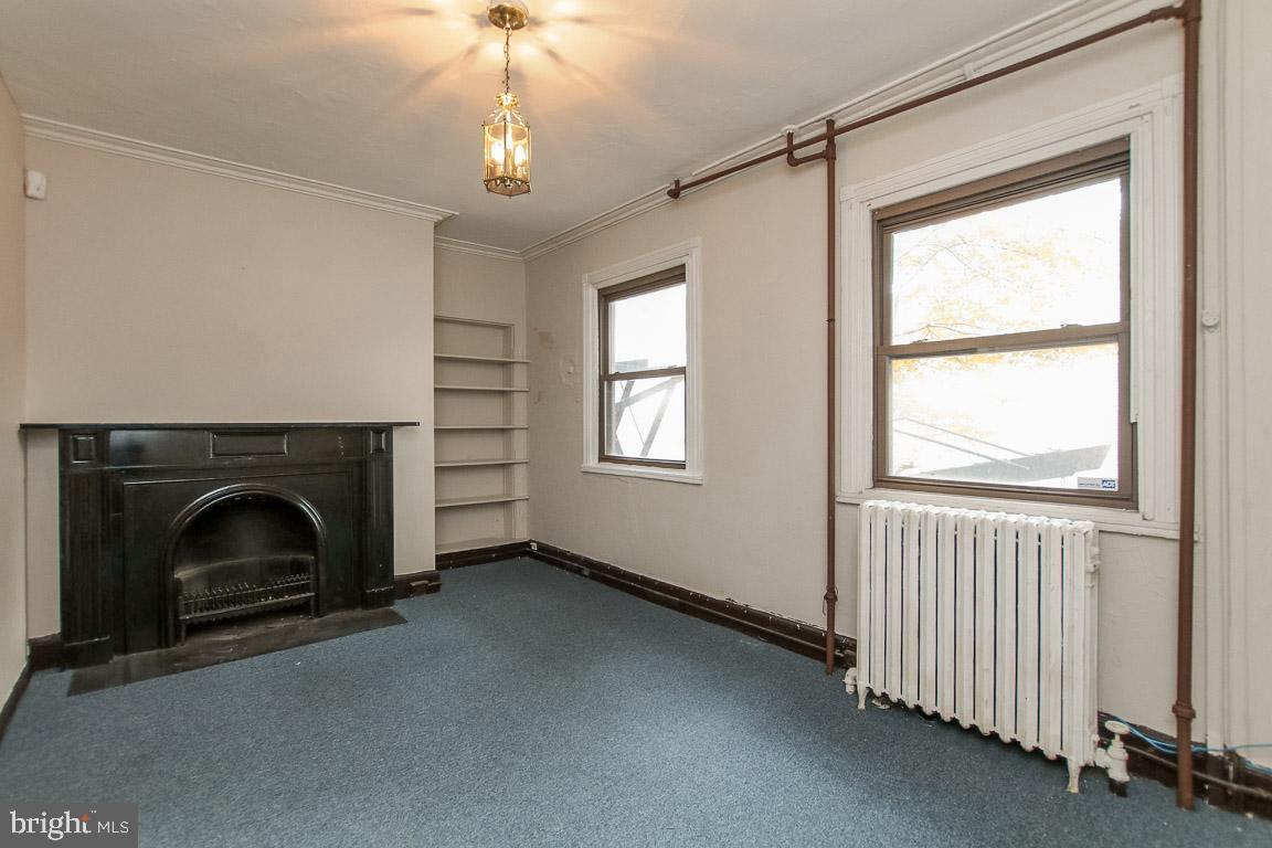 18 West Franklin Street Baltimore, MD 21201 - Photo 19 of 58 a view of empty room with fireplace and fan