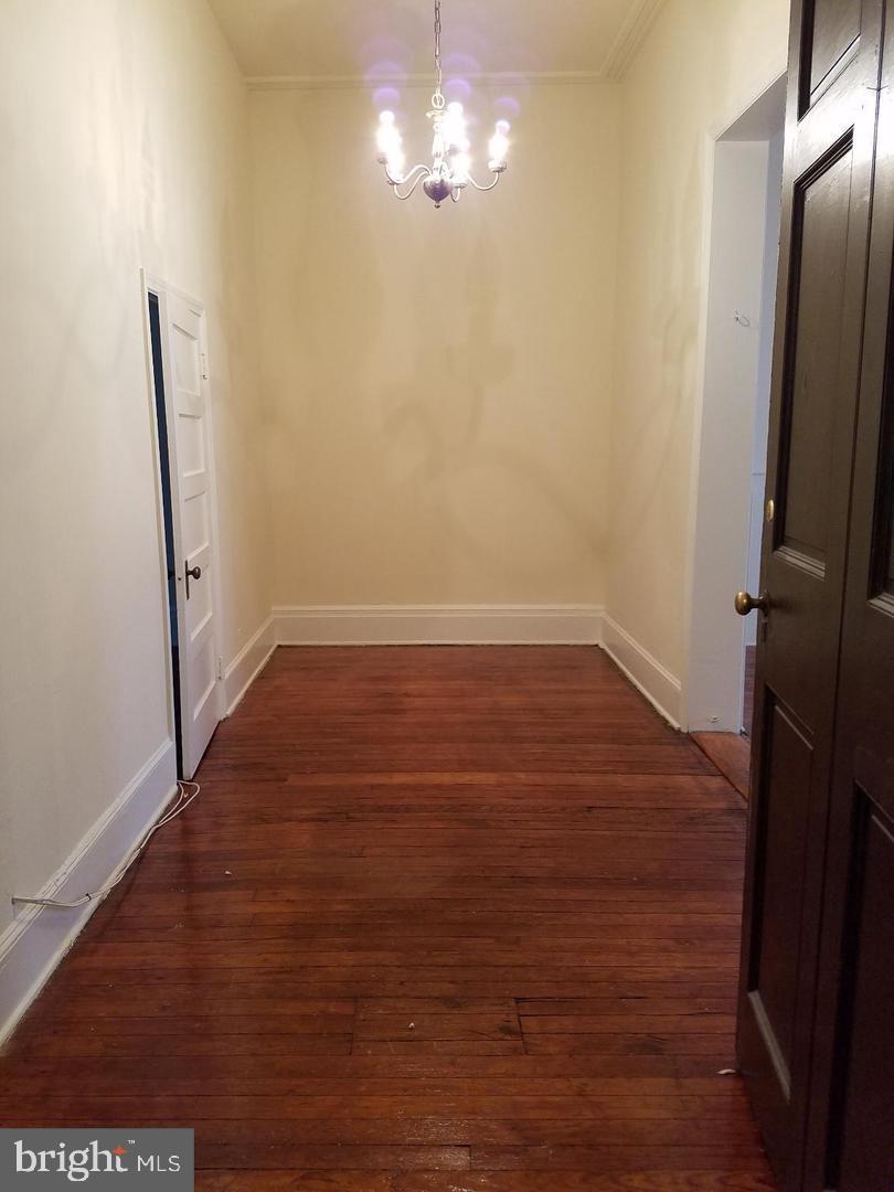 18 West Franklin Street Baltimore, MD 21201 - Photo 22 of 58 a view of empty room with wooden floor