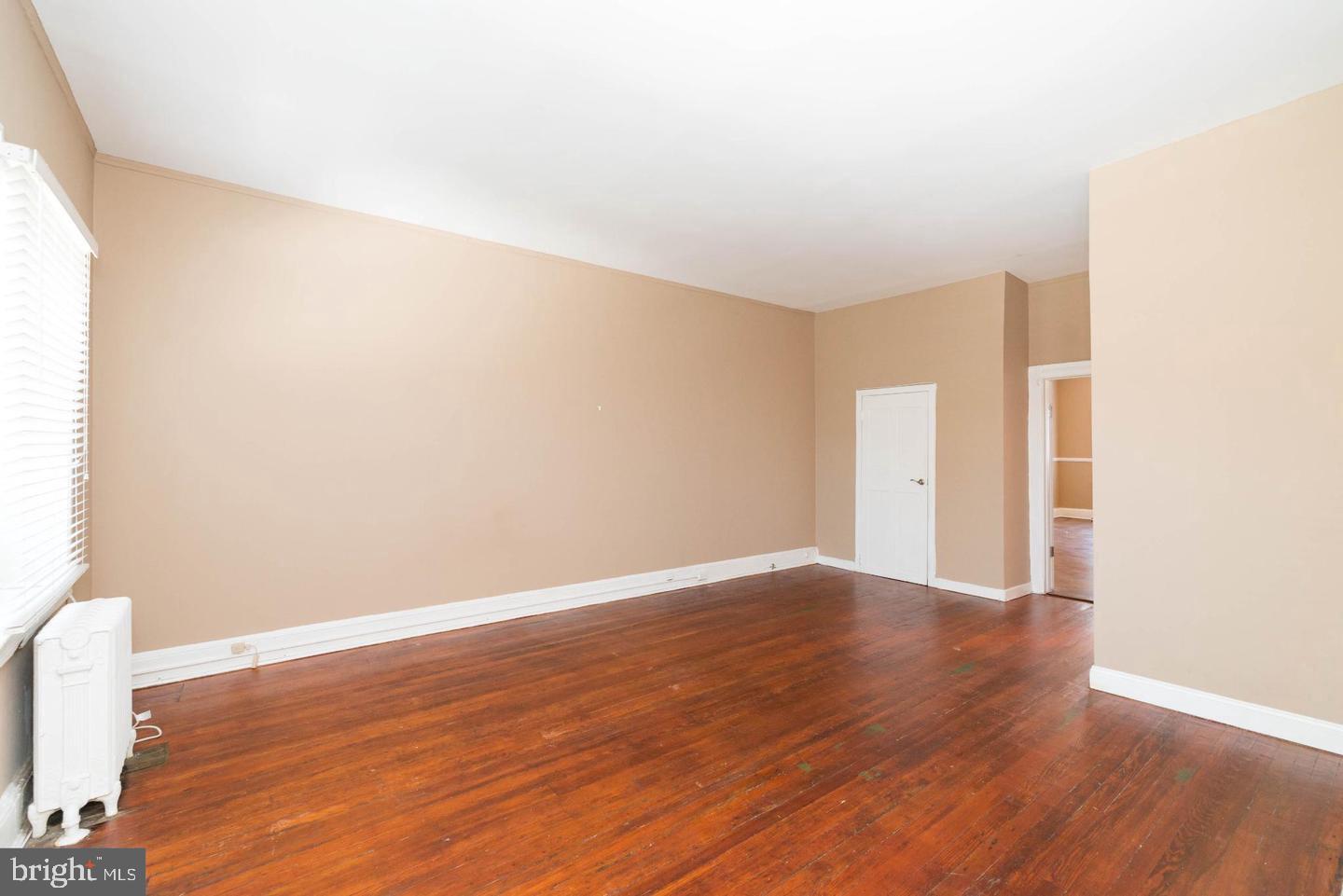 18 West Franklin Street Baltimore, MD 21201 - Photo 36 of 58 a view of an empty room with wooden floor