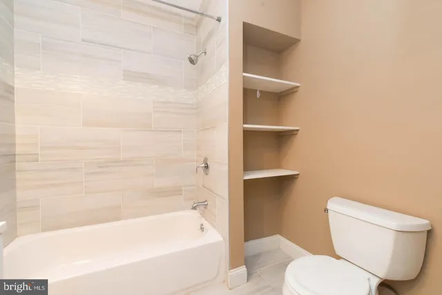 a view of empty room with fireplace