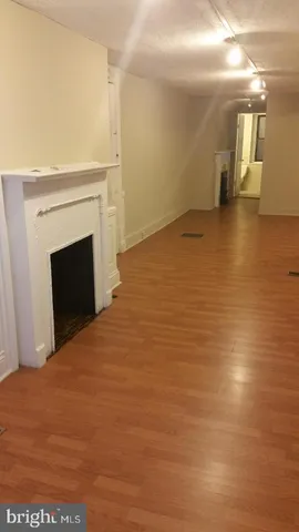 a view of a kitchen with wooden floor