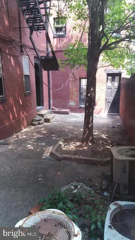 a view of a kitchen with wooden floor and a refrigerator