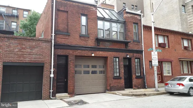 a view of a kitchen with wooden floor and staircase