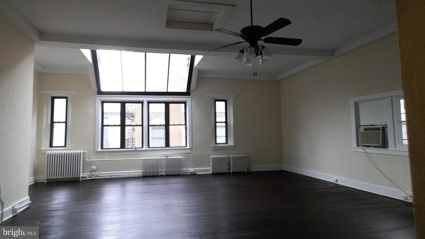 18 West Franklin Street Baltimore, MD 21201 - Photo 50 of 58 a view of an empty room with wooden floor and a window
