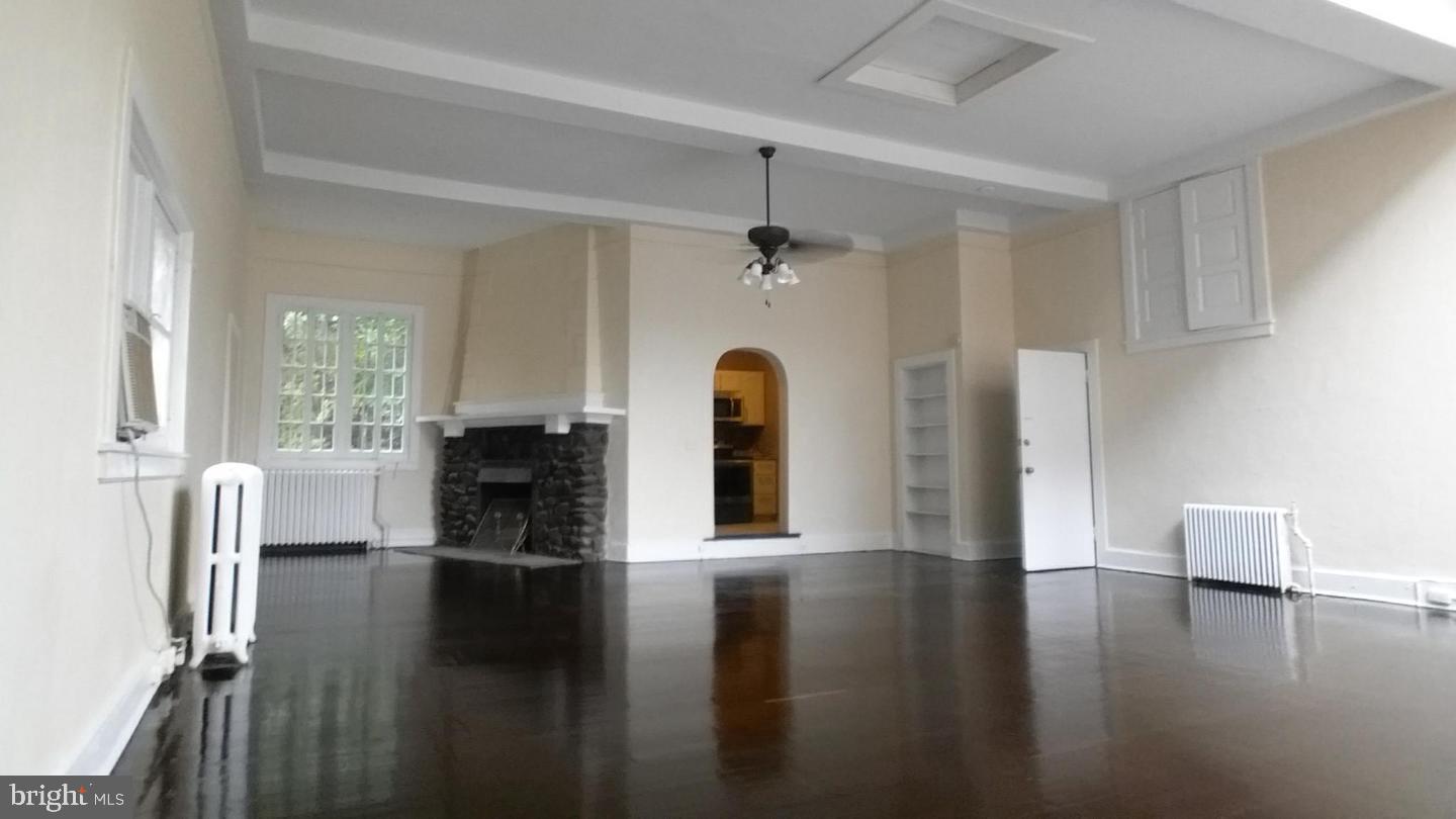 18 West Franklin Street Baltimore, MD 21201 - Photo 51 of 58 a view of empty room with fireplace and wooden floor