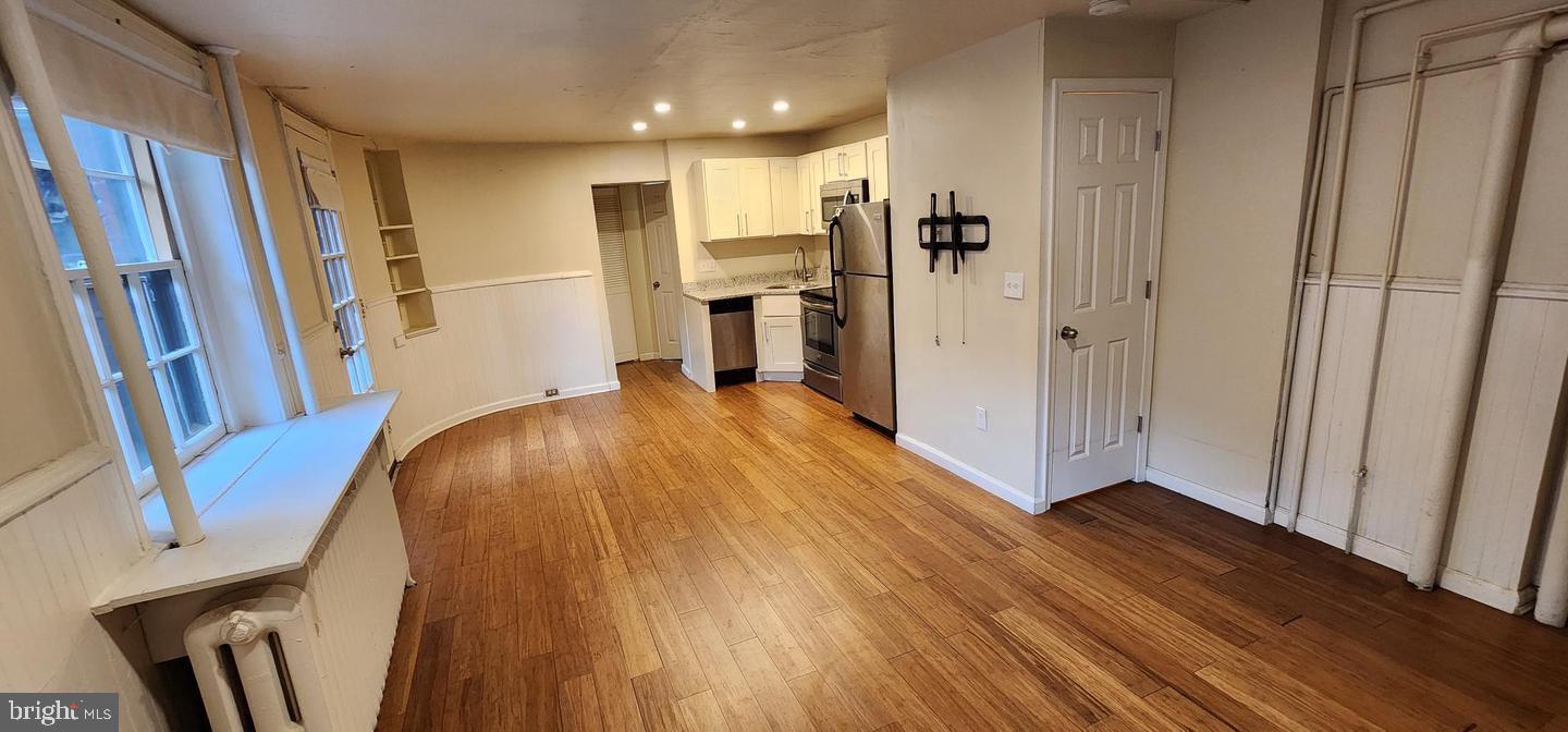 18 West Franklin Street Baltimore, MD 21201 - Photo 56 of 58 a view of a kitchen with wooden floor and a refrigerator
