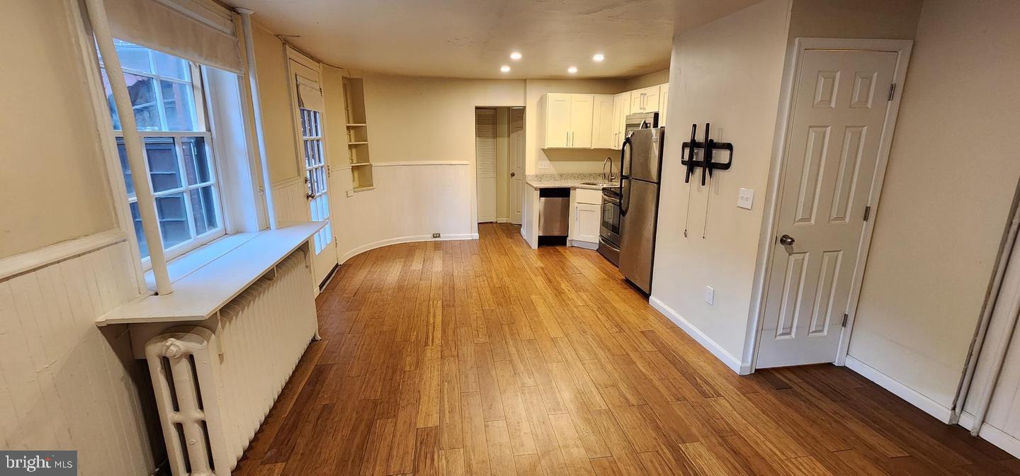 18 West Franklin Street Baltimore, MD 21201 - Photo 57 of 58 a view of a kitchen with wooden floor and staircase