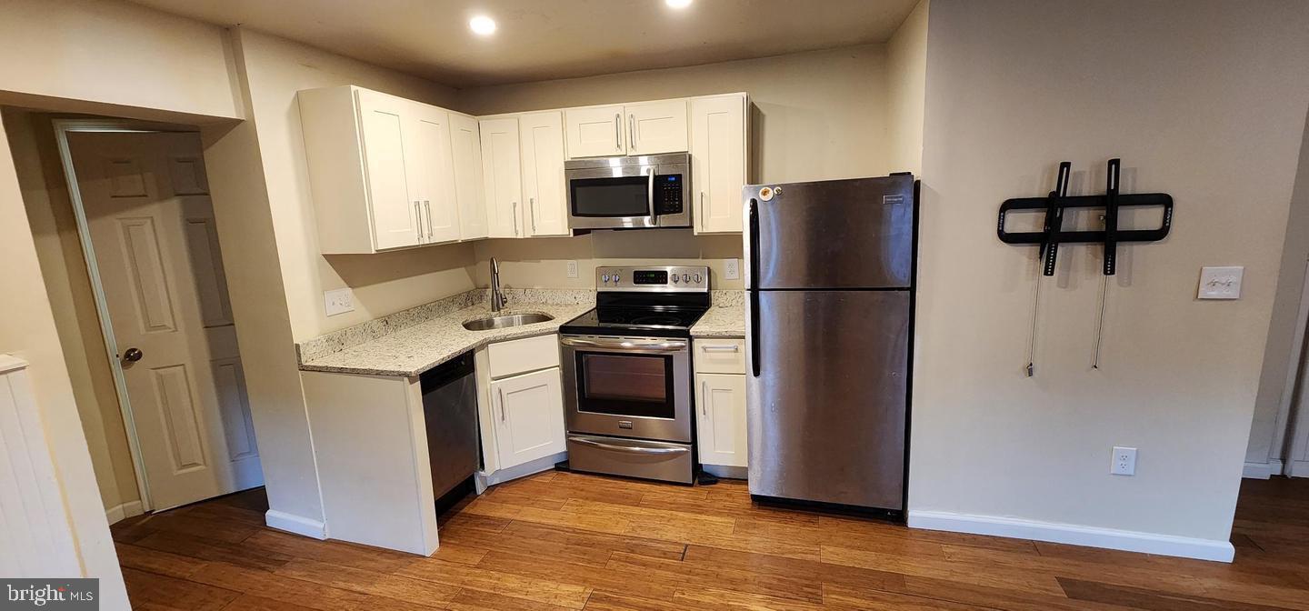 18 West Franklin Street Baltimore, MD 21201 - Photo 58 of 58 a kitchen with a refrigerator sink and microwave