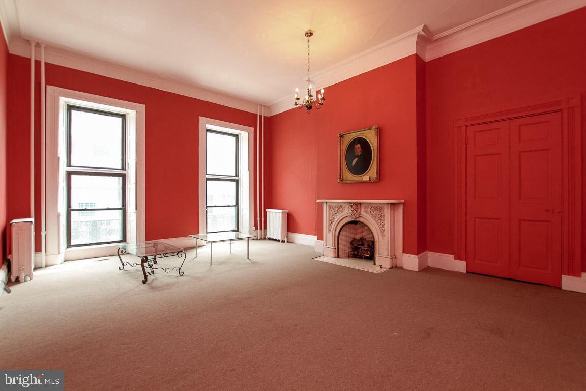 18 West Franklin Street Baltimore, MD 21201 - Photo 10 of 58 a view of a livingroom with fireplace fan and windows