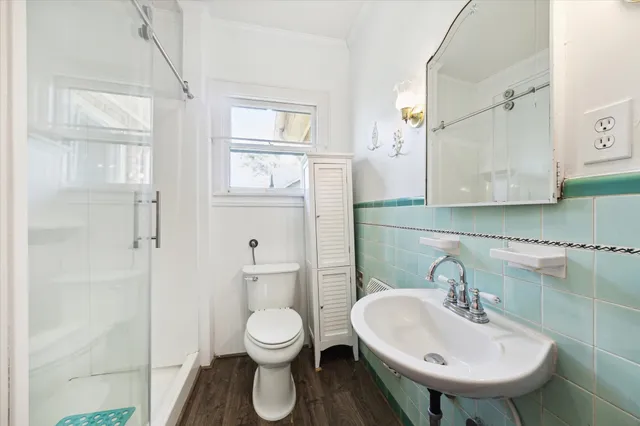 a bathroom with a sink toilet and shower