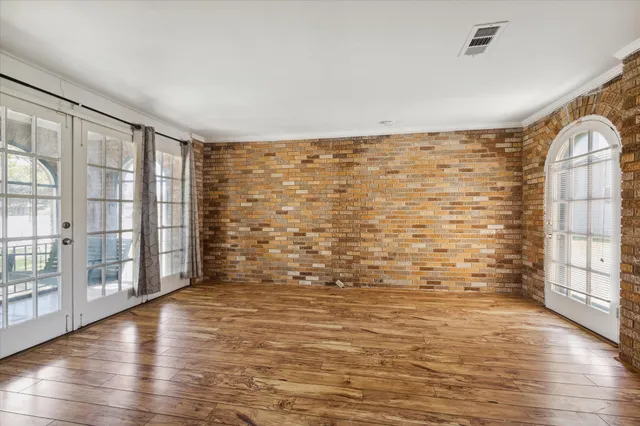 a view of room with window and wooden floor
