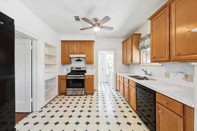 a kitchen with stainless steel appliances a stove a sink and a refrigerator