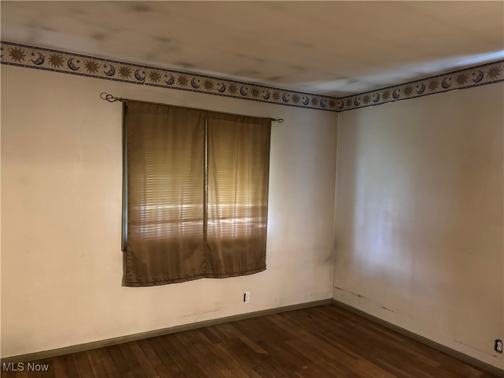 115 Lee Road Painesville, OH 44077 - Photo 12 of 19 Bedroom with baseboards and dark wood finished floors