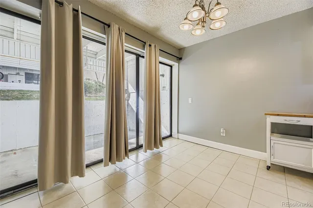 an empty room with windows and entrance