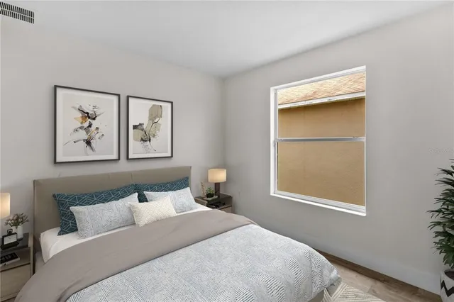 a bedroom with a bed and a window