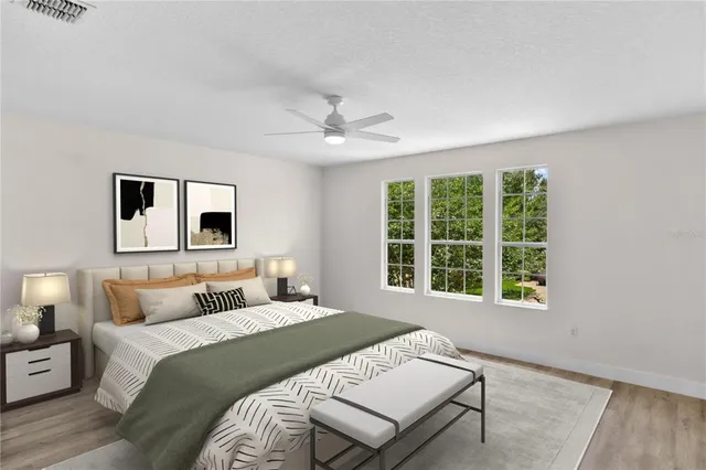 a bedroom with a large bed and a window