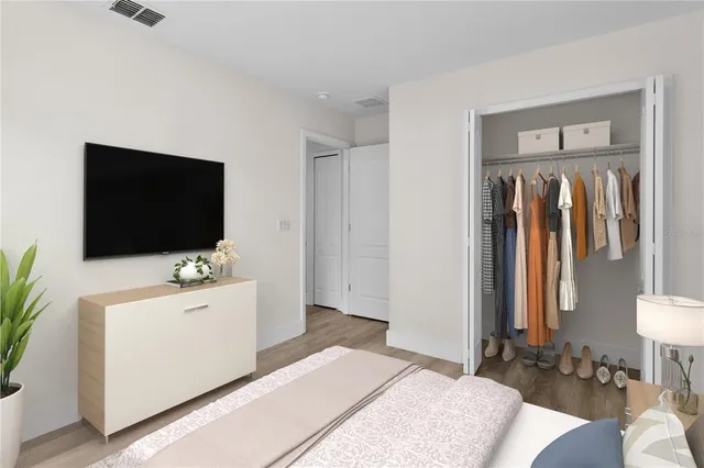 a bedroom with a bed and a flat screen tv