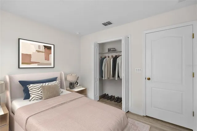 a bedroom with a bed and a closet