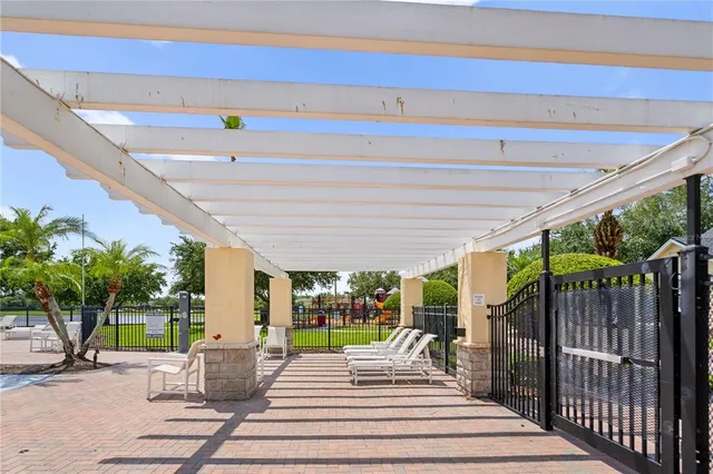 a view of a patio with a dining table and chairs with wooden floor and fence