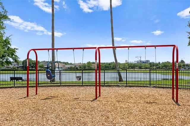 a view of a tennis ground with large trees