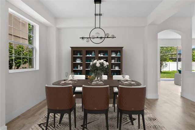 a view of a dining room with furniture window and wooden floor