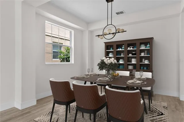 a dining room with furniture and window