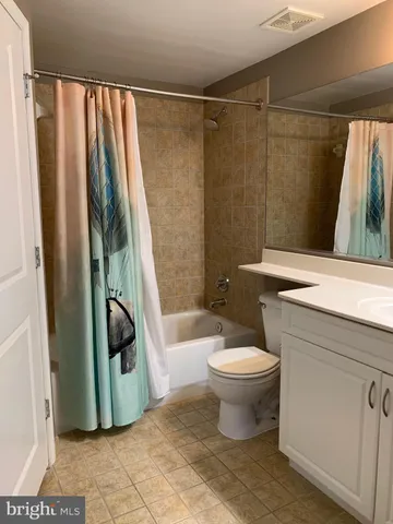 a bathroom with a sink a toilet and a shower