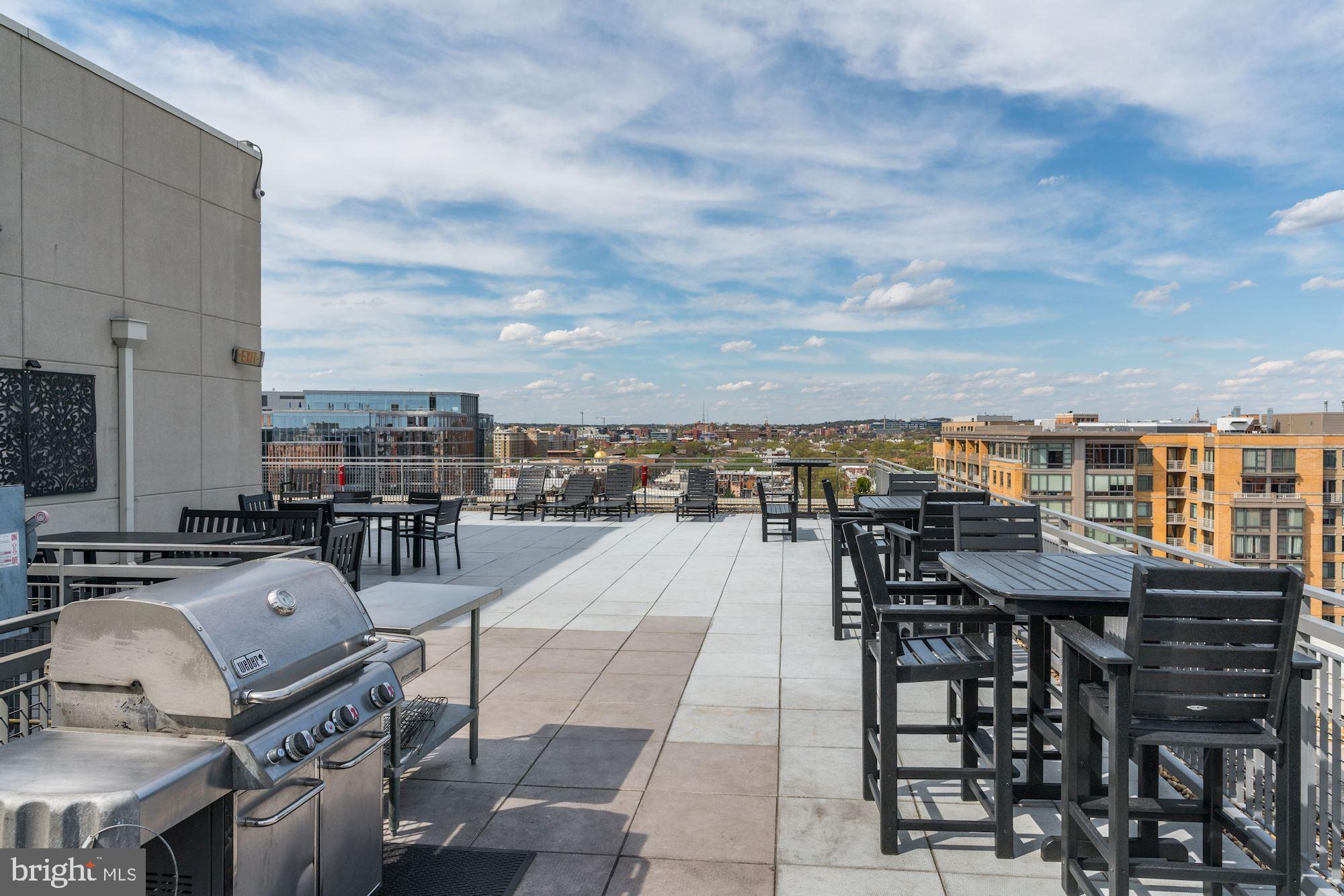 555 Massachusetts Avenue Northwest, Unit 503 Washington, DC 20001 - Photo 19 of 24 a terrace with outdoor seating city view and barbeque oven