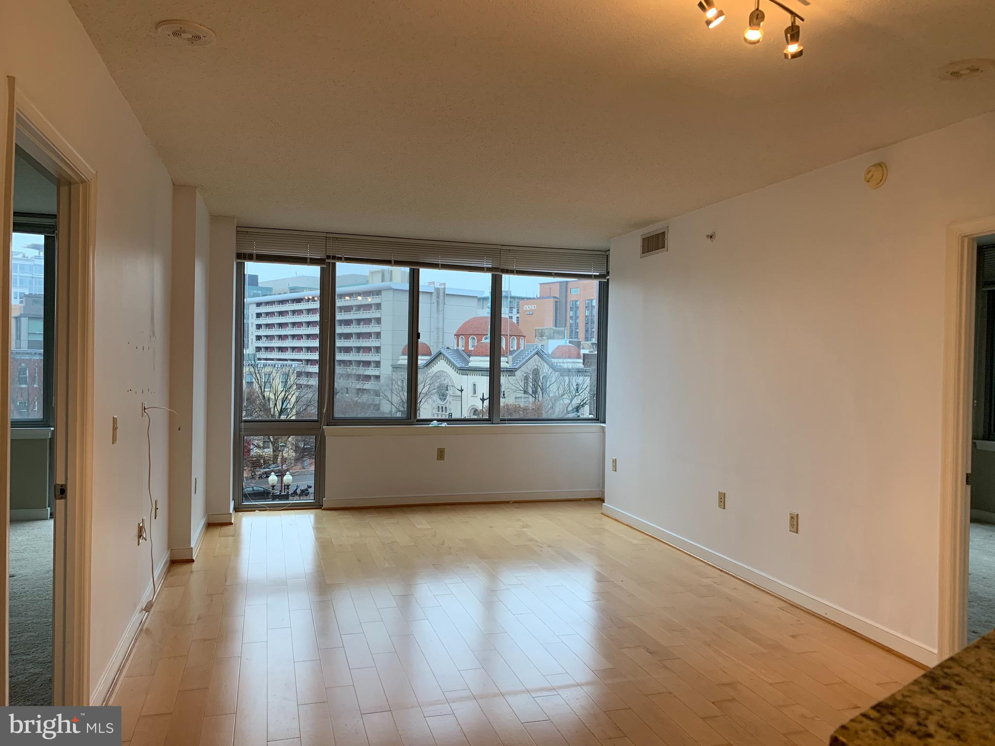 555 Massachusetts Avenue Northwest, Unit 503 Washington, DC 20001 - Photo 2 of 24 wooden floor in an empty room with a window