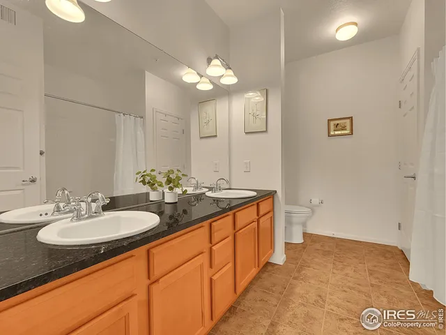a bathroom with a sink double vanity and a mirror