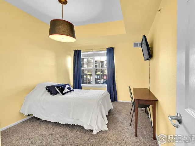 a bedroom with a bed and a table