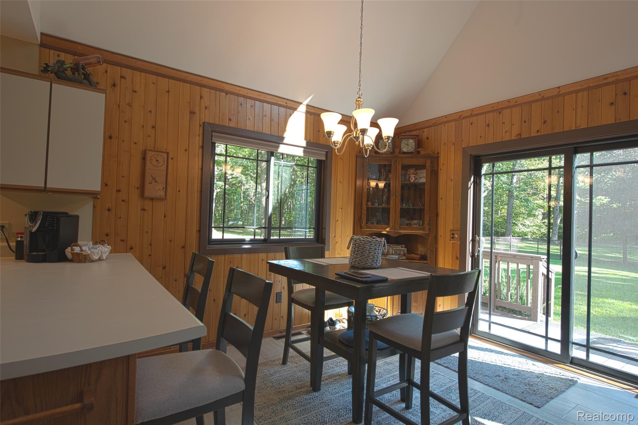 5799 Goodar Road South Branch, MI 48761 - Photo 16 of 58 Open dining area with Wood-paneled walls and a vaulted ceiling
