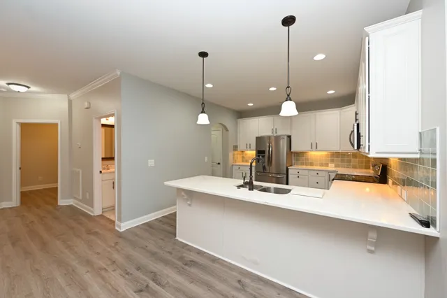 a large kitchen with a large center island in it
