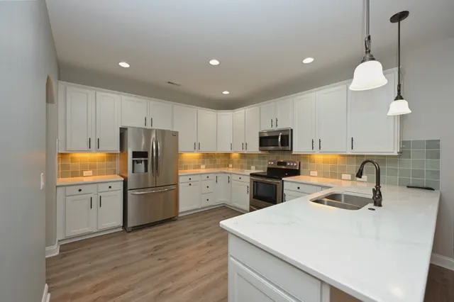 a kitchen with refrigerator cabinets and wooden floor