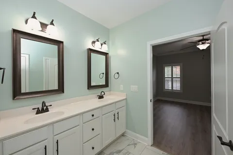 a bathroom with double sink and a mirror