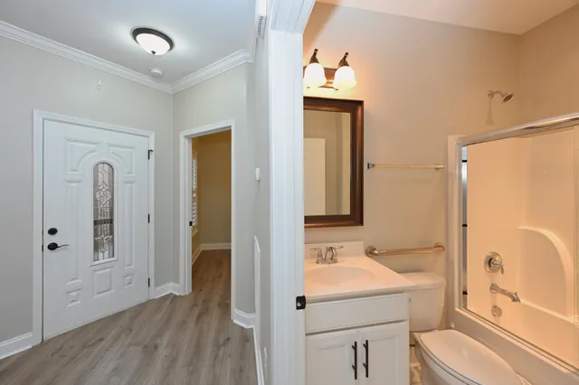 a bathroom with a sink a toilet and shower