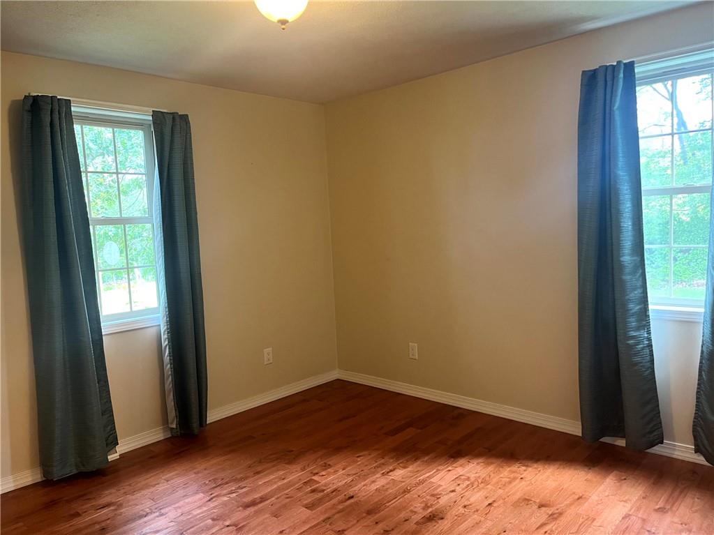 75 Cave Street Fairchance, PA 15436 - Photo 13 of 36 an empty room with wooden floor and windows
