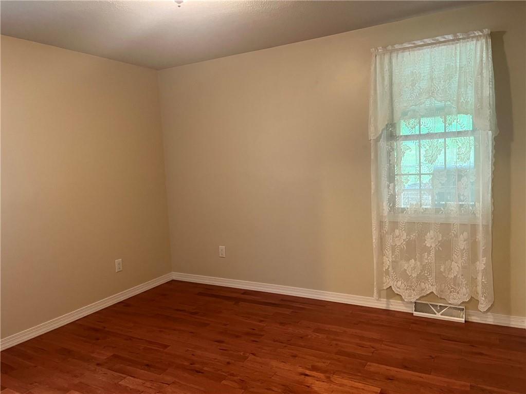 75 Cave Street Fairchance, PA 15436 - Photo 19 of 36 an empty room with wooden floor and windows