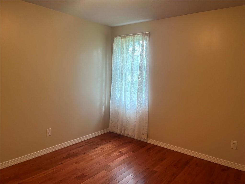 75 Cave Street Fairchance, PA 15436 - Photo 21 of 36 an empty room with wooden floor and windows