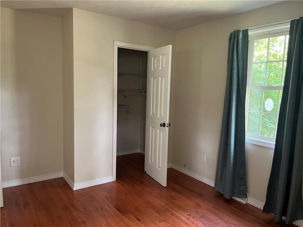 75 Cave Street Fairchance, PA 15436 - Photo 22 of 36 an empty room with wooden floor and windows