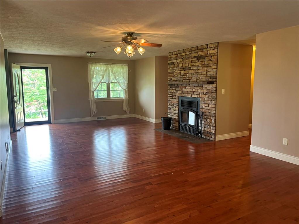 75 Cave Street Fairchance, PA 15436 - Photo 3 of 36 a view of a livingroom with wooden floor and a fireplace