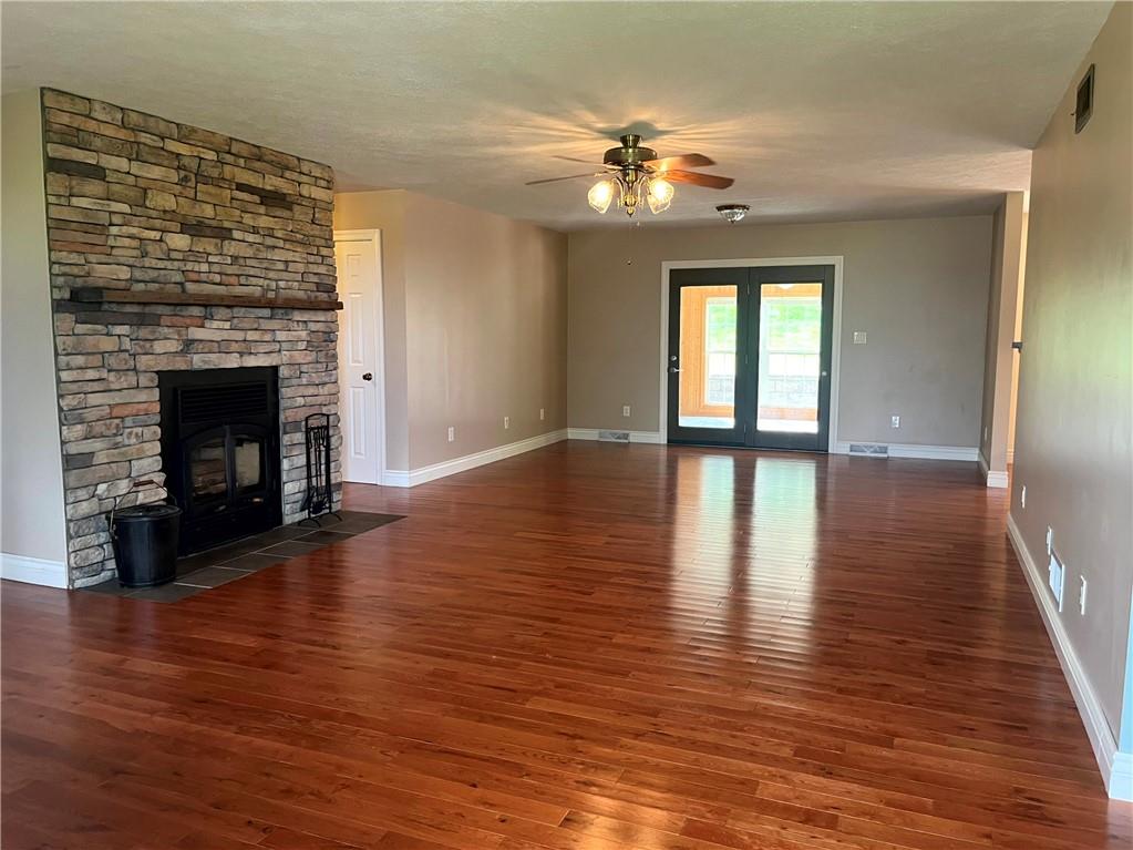 75 Cave Street Fairchance, PA 15436 - Photo 4 of 36 a view of an empty room with wooden floor fireplace and a window