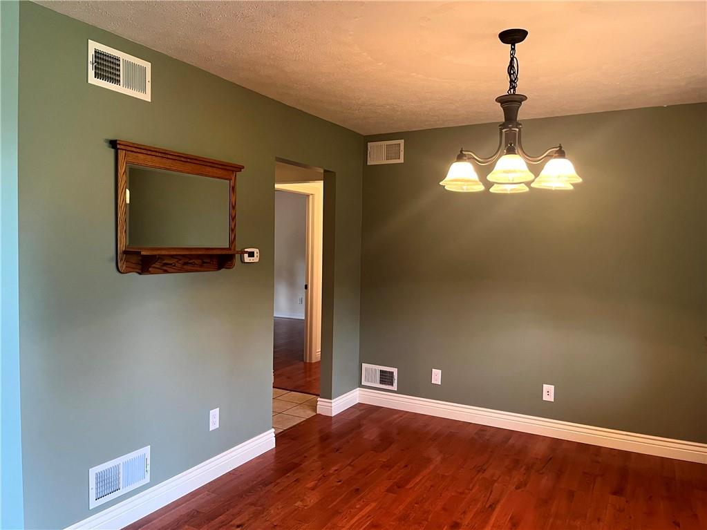 75 Cave Street Fairchance, PA 15436 - Photo 6 of 36 a view of a room with wooden floor and chandelier