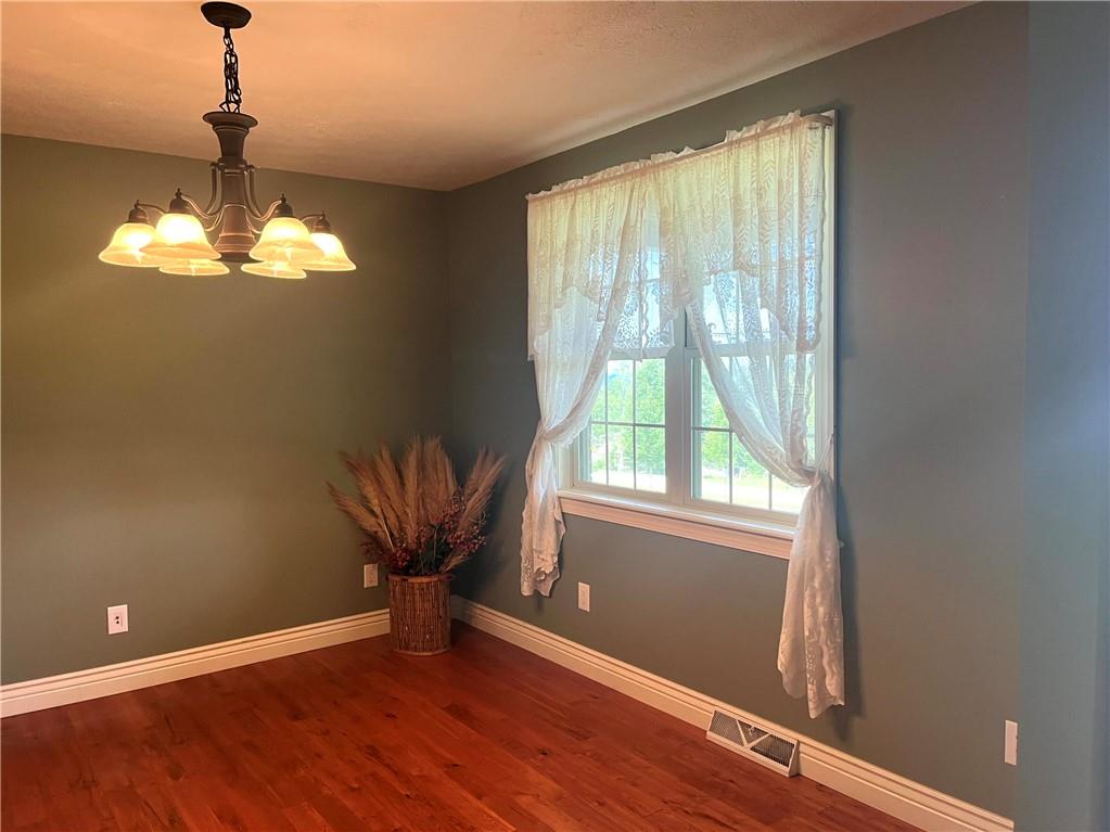 75 Cave Street Fairchance, PA 15436 - Photo 7 of 36 a view of a livingroom with a chandelier wooden floor and a chandelier