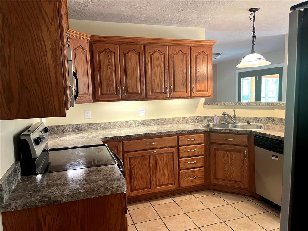 75 Cave Street Fairchance, PA 15436 - Photo 9 of 36 a kitchen with granite countertop a sink stove and cabinets