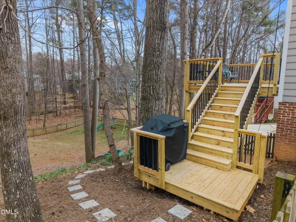 a view of balcony with wooden floor and fence