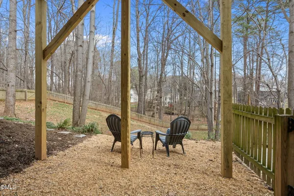 a view of a backyard with couches and wooden fence