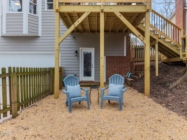a backyard of a house with table and chairs