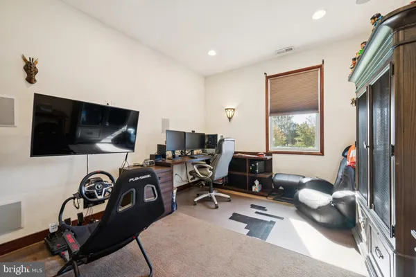 a workspace with a flat screen tv and a large window