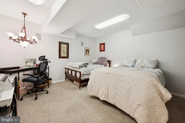a bedroom with bed and a chandelier